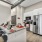 Spacious and well lit kitchen with wood flooring and stainless steel appliances