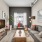 Spacious and well lit living room with wood flooring, large windows and open access to the kitchen