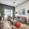 Spacious and well lit living room with wood flooring, large windows and open access to the kitchen