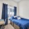 Large well lit bedroom with plush carpets and large windows 