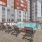 Large sparkling blue pool with a large pool deck and lounge chairs