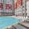 Large sparkling blue pool with a large pool deck and lounge chairs
