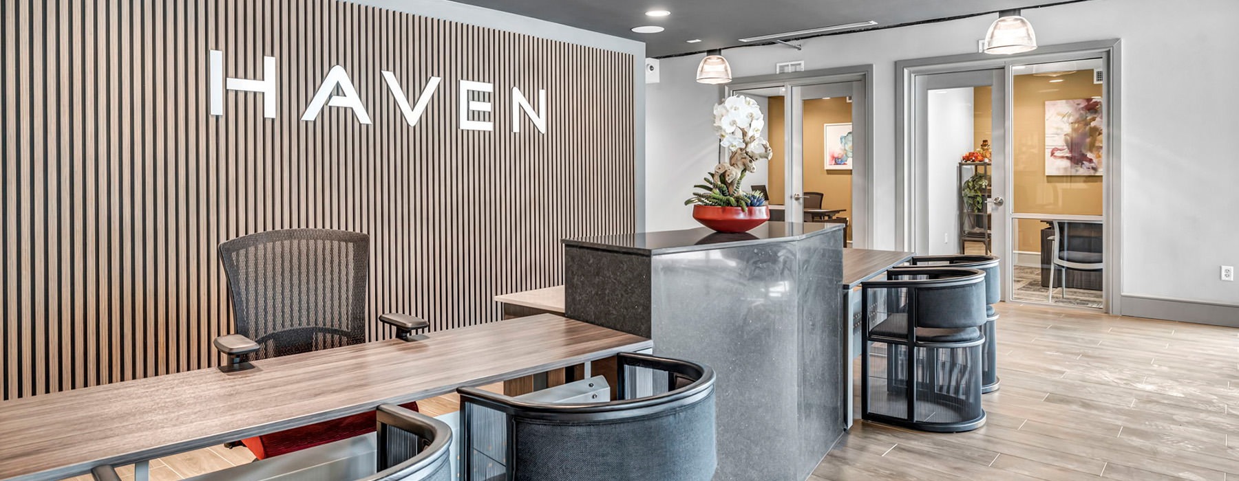 lobby with large wood wall and the Haven logo